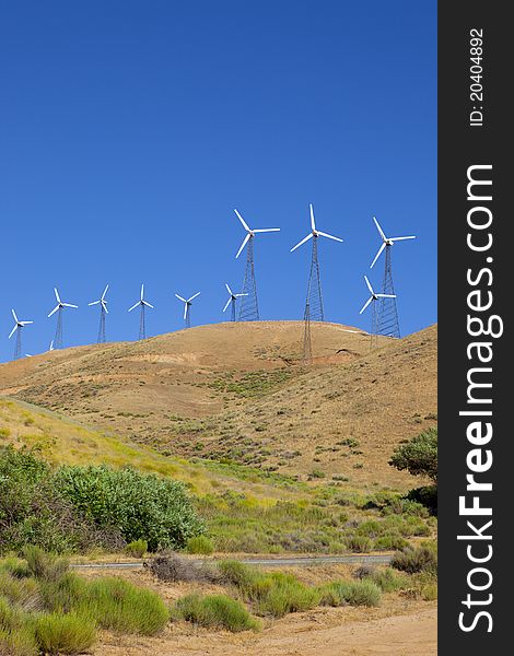 Wind turbines on top of a hillside. Wind turbines on top of a hillside.