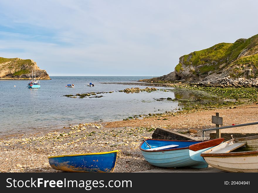 Small fishing boats in Lulworth Cove. Dorset, England.