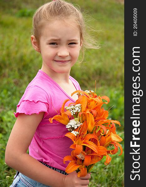 Girl with a bouquet of orange lilies. Girl with a bouquet of orange lilies