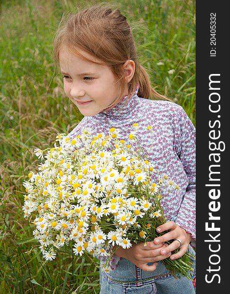 Girl with a bouquet of daisies field