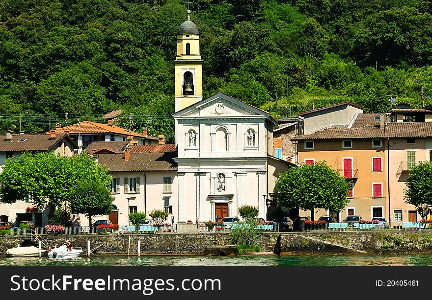 Church and houses on the shore of lake Lugano Ticino Switzerland