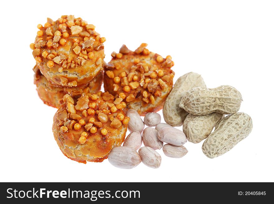 Close up of coated cookie and peanuts isolated on white background. Close up of coated cookie and peanuts isolated on white background.