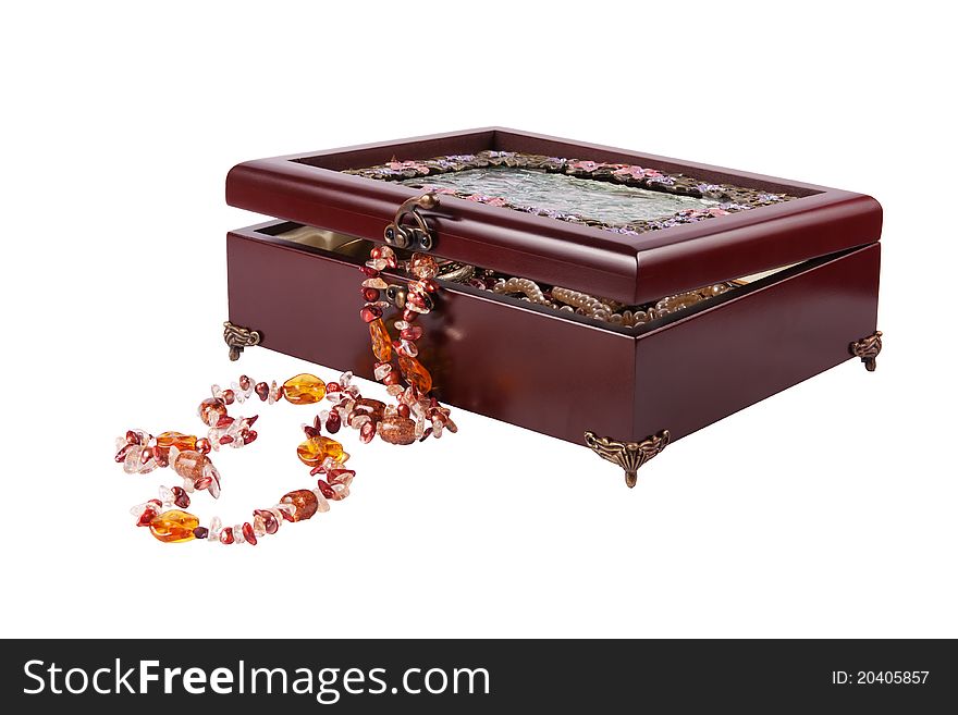 Wooden casket with jewelry. beads lies near to the casket.