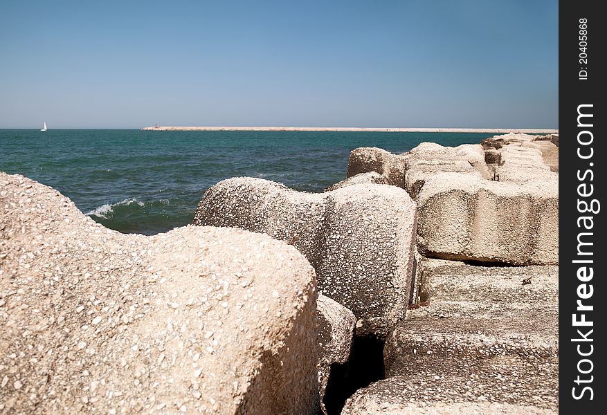 Stone embankment in the sea near the coast