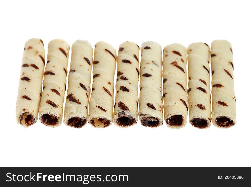 Close up of many milk chocolate scroll isolated on white background.