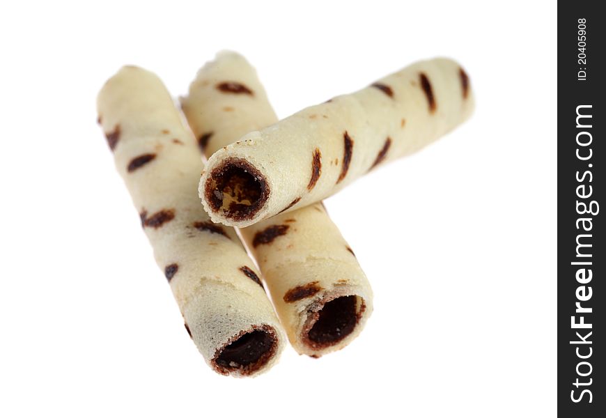 Close up of many milk chocolate scroll isolated on white background.