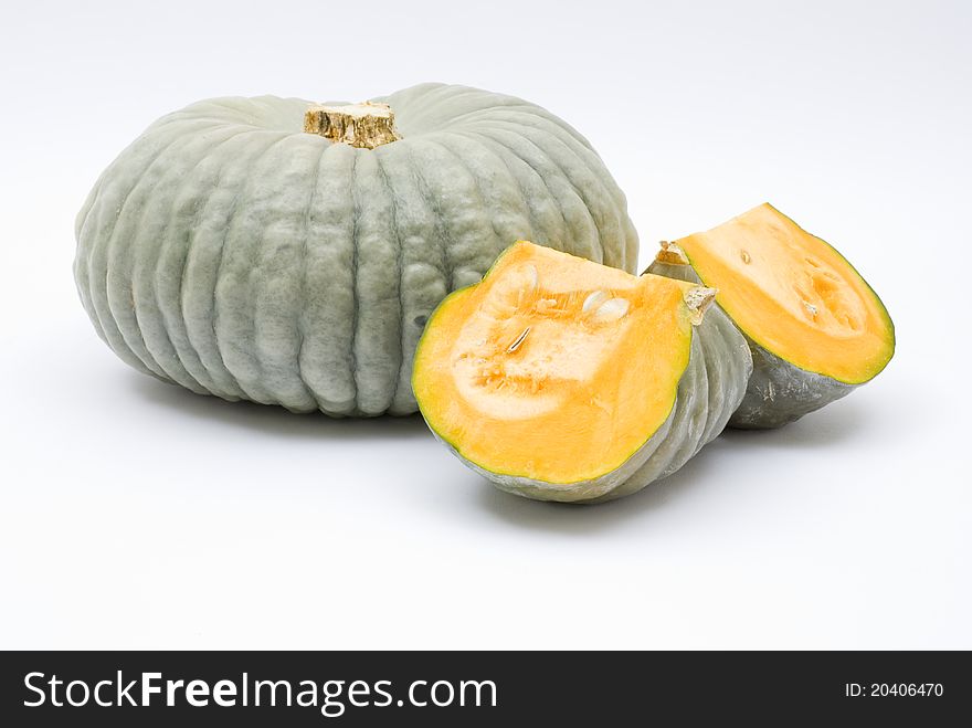 Fresh pumpkin, whole and cut, on a white background