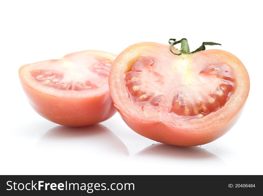 Fresh tomatoes, slicedâ€‹â€‹, on a white background
