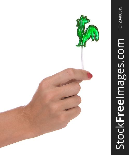 Lollipop in a hand isolated over white background