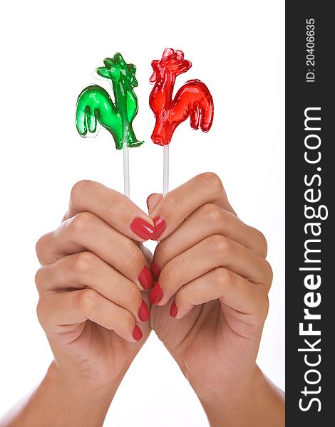 Lollipop in a hand isolated over white background