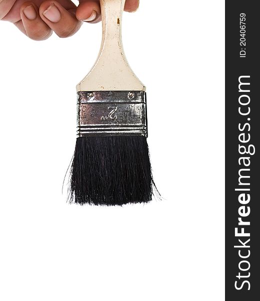 Paintbrush in hand isolated on white background