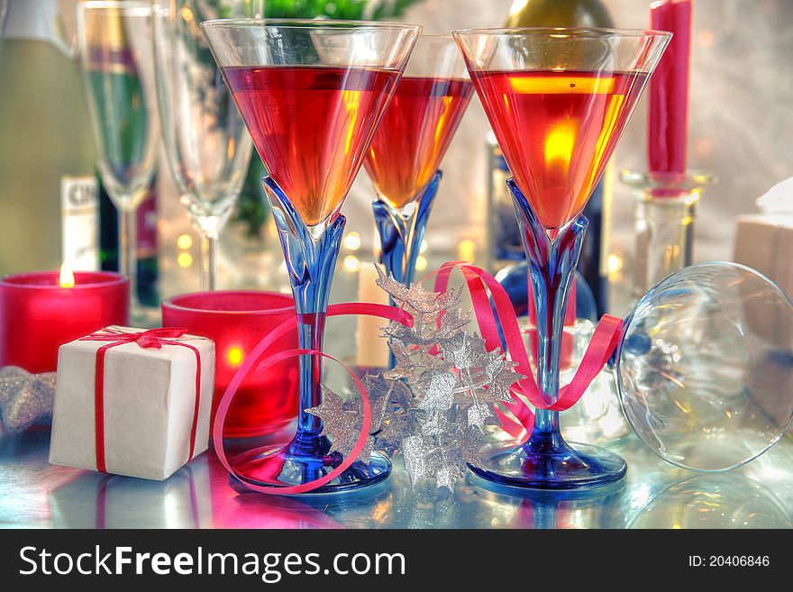 Red wine in glasses,candle lights and gift on silver background. Red wine in glasses,candle lights and gift on silver background.