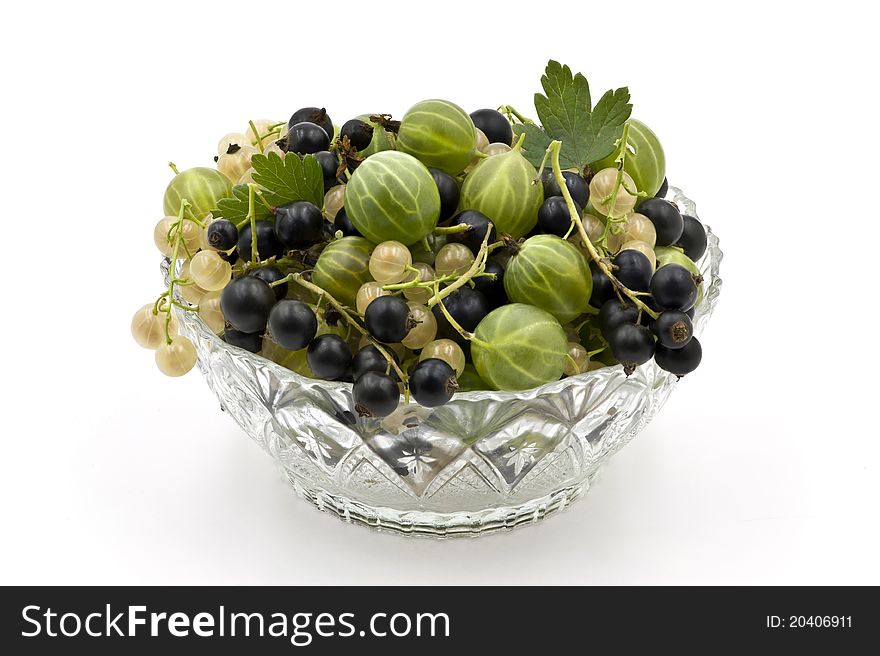 A Glass Dish Full of Gooseberies and Currants on the White Background