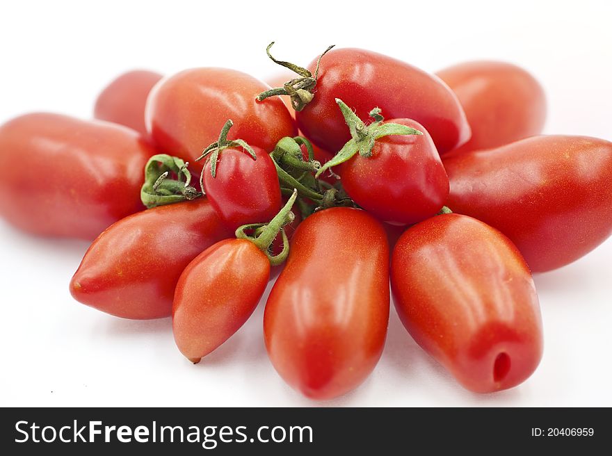Organic Tomatoes Beside Each Other on the White Background. Organic Tomatoes Beside Each Other on the White Background