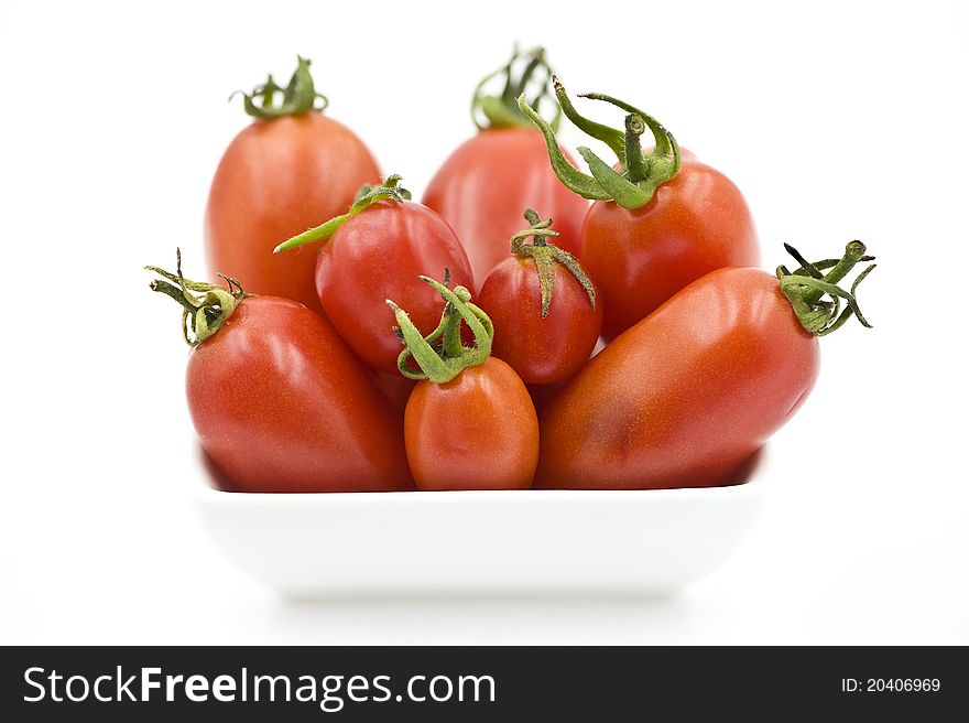 Organic Tomatoes in a Dish on the White Background