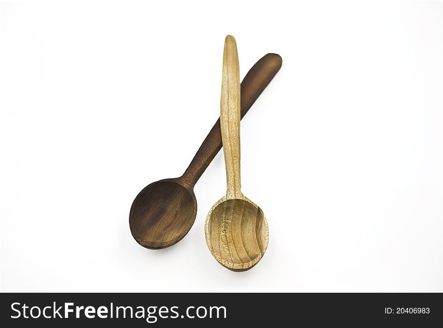 Two Wooden Spoons on the White Background. One dark and one light spoons