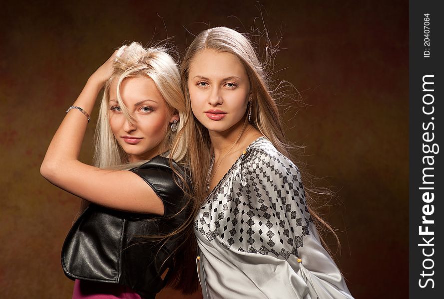 Two pretty women on a colored background