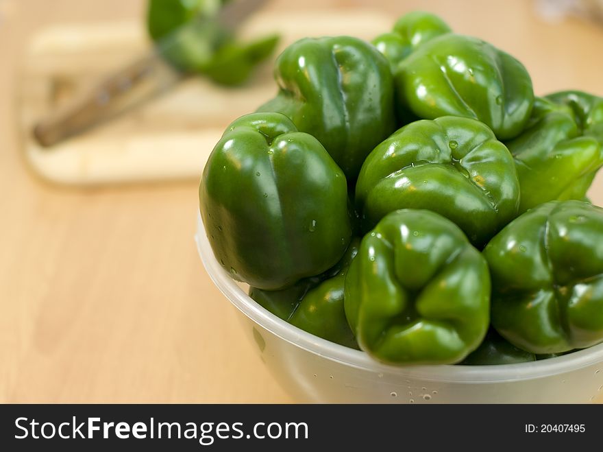 Green fresh peppers on the bowl