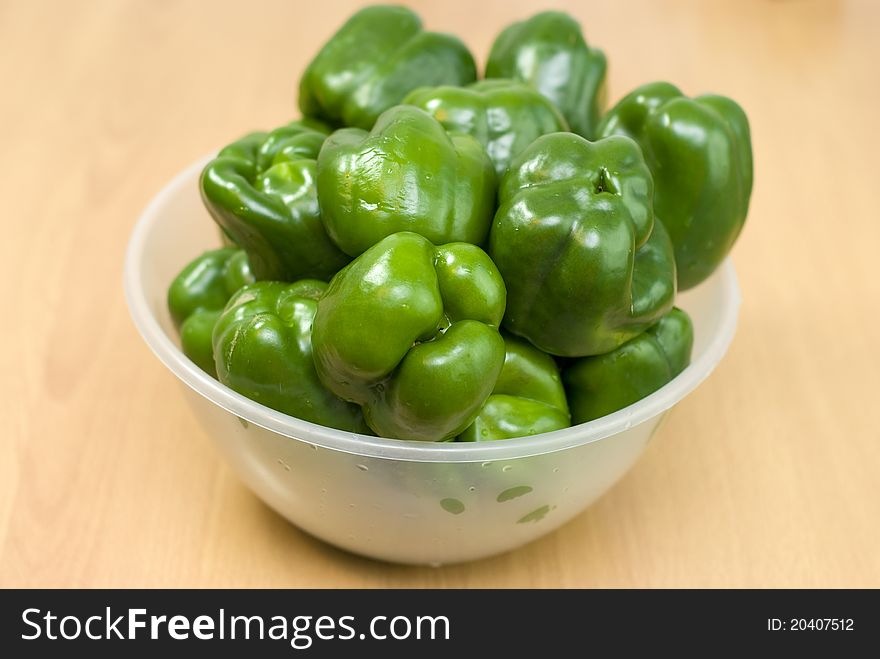 Green fresh peppers on the bowl