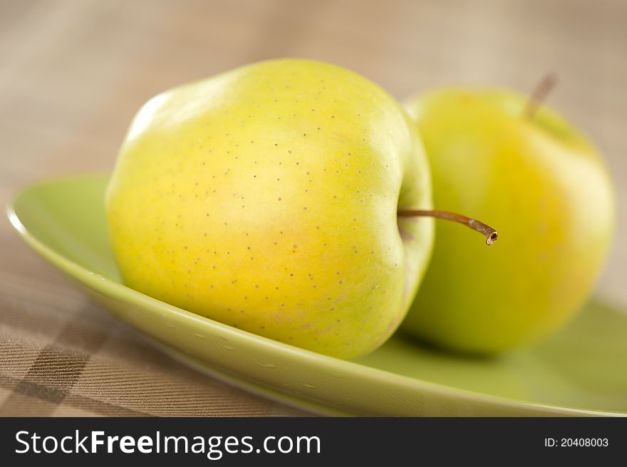 Closeup of fresh green apple on plate