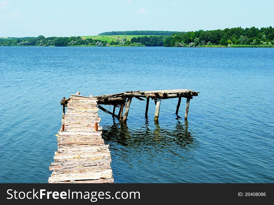 View Of The River With A Wooden Pier