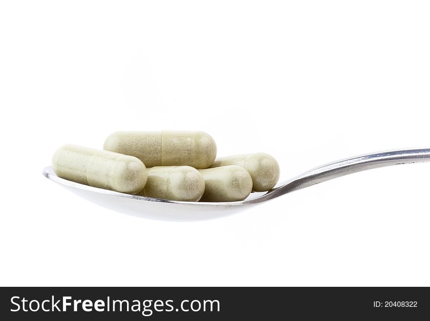 Isolated spoon of drugs in white background