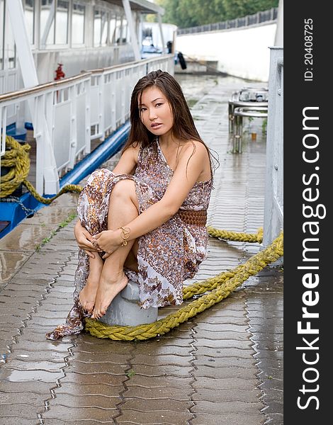 Girl walking outdoor on embankment under rain