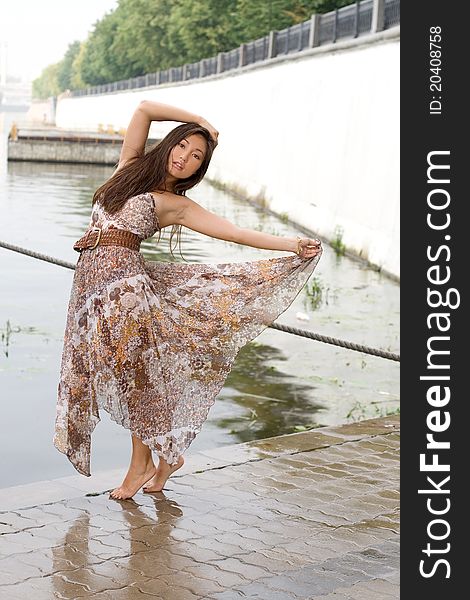 Beautiful girl walking near river