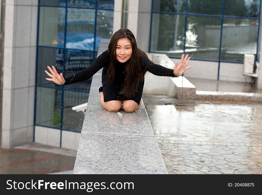 Sexy girl in black dress walking in city