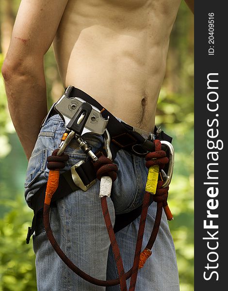 Equipment climber rope belt cord lock on the body of an athlete. Equipment climber rope belt cord lock on the body of an athlete