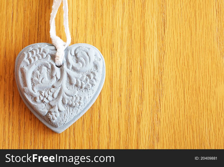 Stone heart shape on wooden background