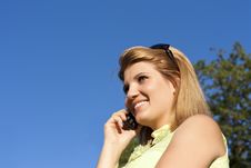 Young Smiling Woman Speaks By Mobile Phone. Stock Photography Young Smiling Woman Speaks By Mobile Phone. Stock Photography