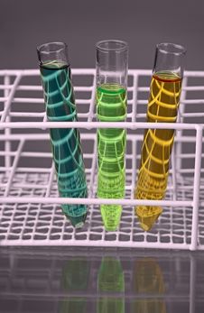 Three Test-tubes With Fluids In A Stand Stock Photos Three Test-tubes With Fluids In A Stand Stock Photos