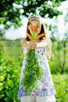 Girl With Carrots Royalty Free Stock Photo