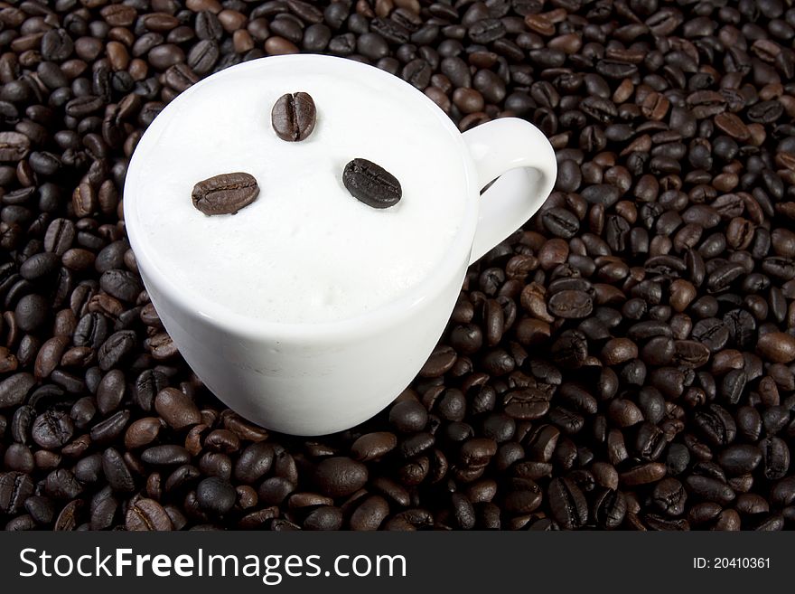 Glass of hot cafe latte on coffee bean background. Glass of hot cafe latte on coffee bean background.
