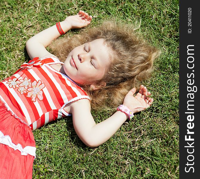 Image of a child lying on the grass in the park. Image of a child lying on the grass in the park