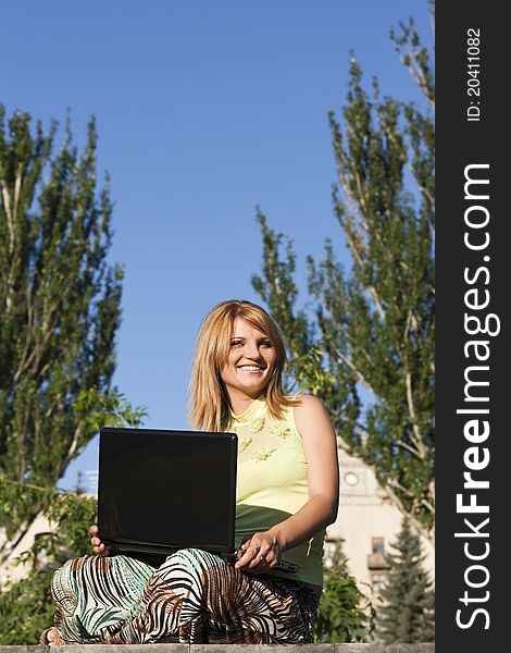 Caucasian woman working on her laptop outdoor. Caucasian woman working on her laptop outdoor