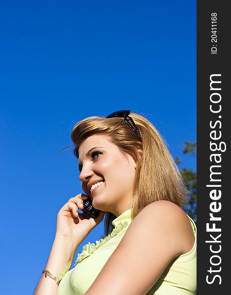Young smiling woman speaks by mobile phone. Young smiling woman speaks by mobile phone.