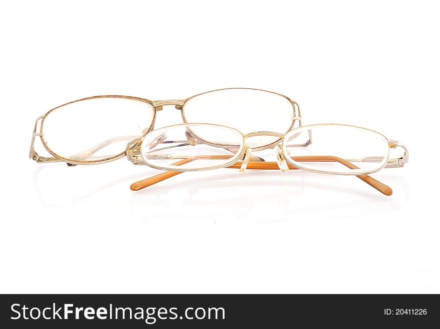 Old glasses on the white background