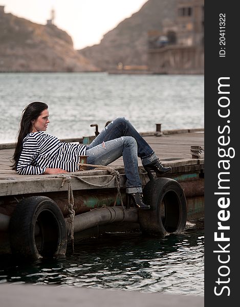 Woman lying on a pier in the background of the sea. Crimea, Ukraine