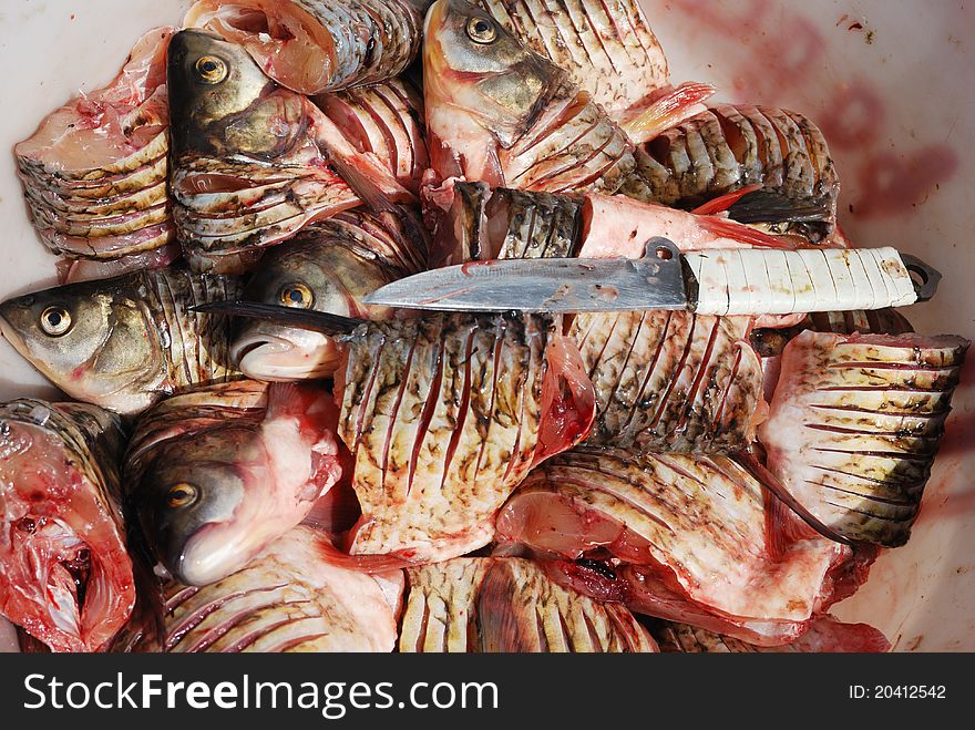 Pieces Of Fresh Raw Fish In And A Knife