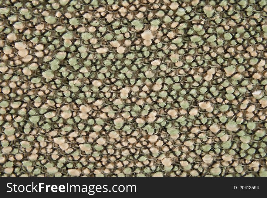 The sample of a carpet fabric. a rough background from a fabric. The sample of a carpet fabric. a rough background from a fabric