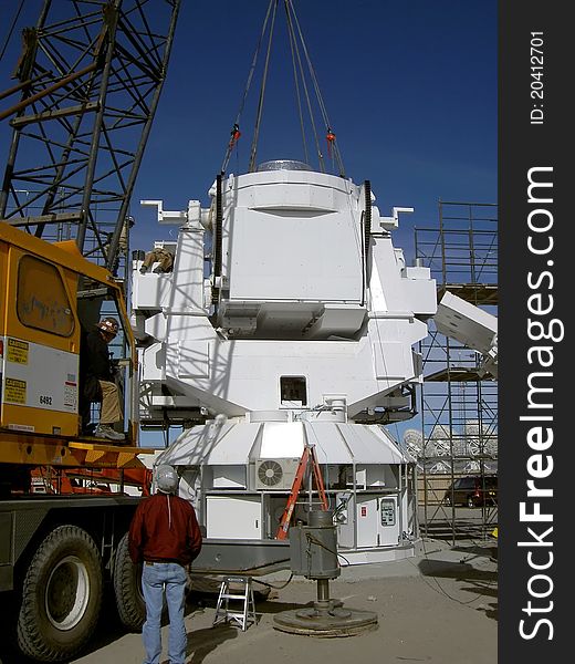 A crew installs the base for a radio astronomy antenna @ the national radio astronomy observatory located @ the 'very large array' in new mexico, usa;. A crew installs the base for a radio astronomy antenna @ the national radio astronomy observatory located @ the 'very large array' in new mexico, usa;