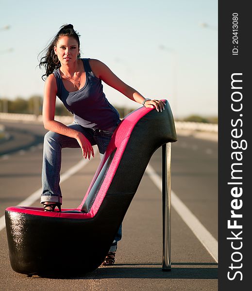 Woman sitting in an armchair on the highway. Woman sitting in an armchair on the highway