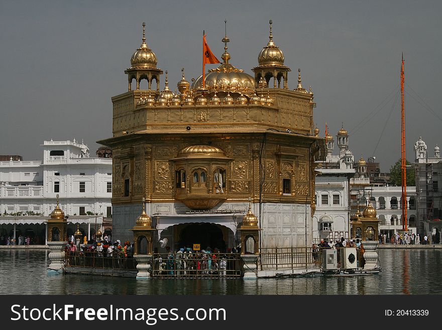 Golden Temple at Amritsar with pilgrims giving worship and prayer