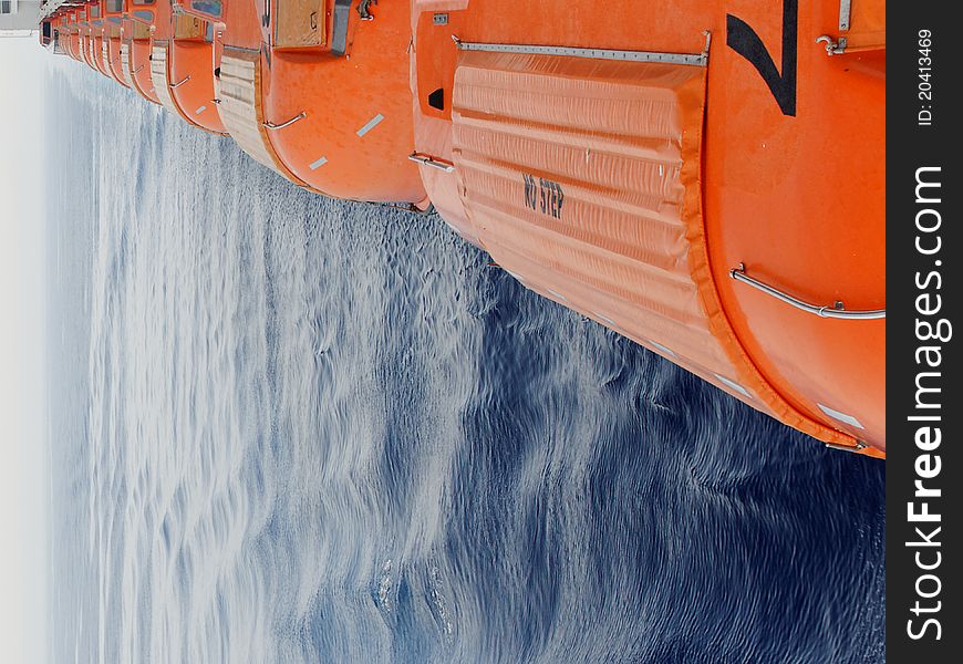 Row of lifeboats on a cruiseship. Row of lifeboats on a cruiseship