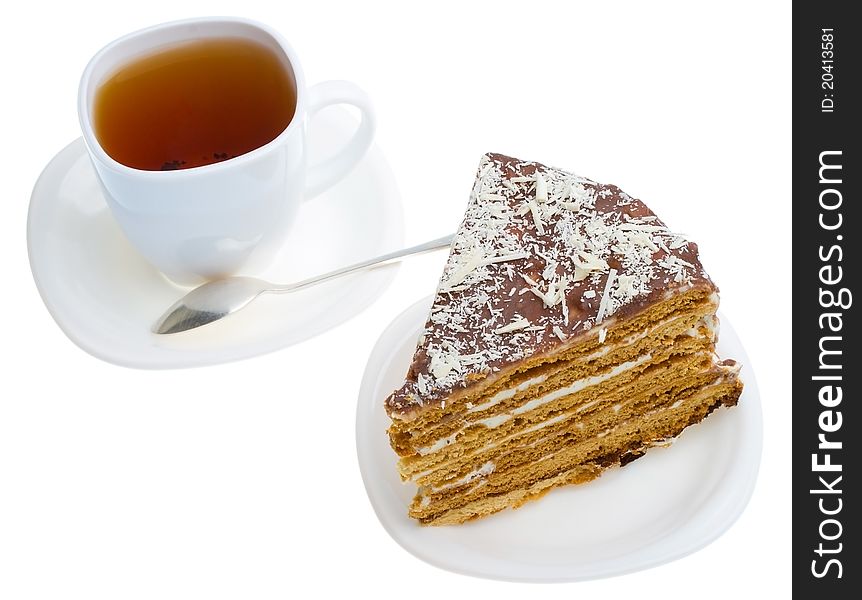 Piece of honey cake and tea cup, isolated on white