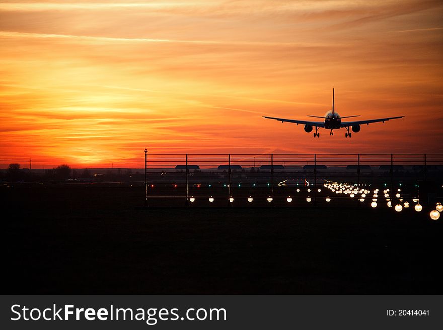 Aircraft touch down at sun down. Aircraft touch down at sun down