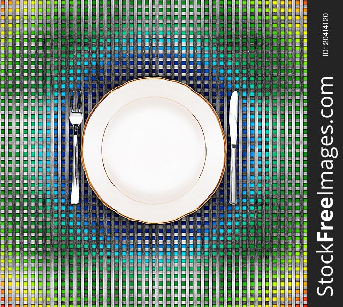 Knife, plate and fork on color grid background