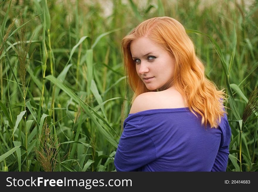 Pretty girl with red haer relaxing outdoor in grass. Pretty girl with red haer relaxing outdoor in grass